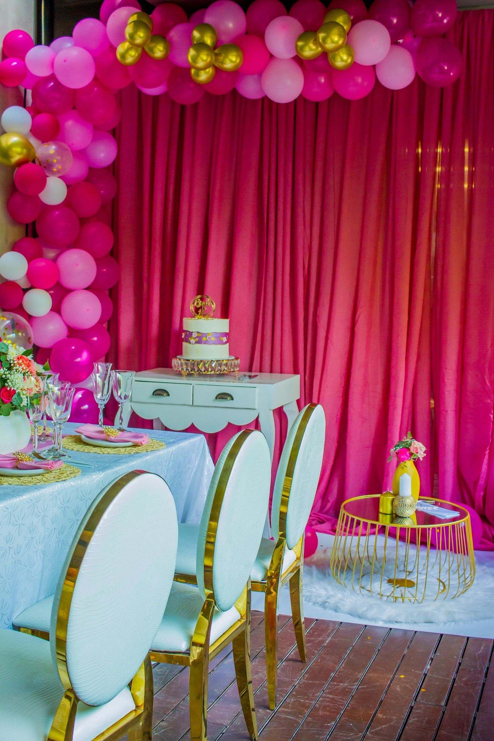 A room with a table and chairs and balloons on the wall.