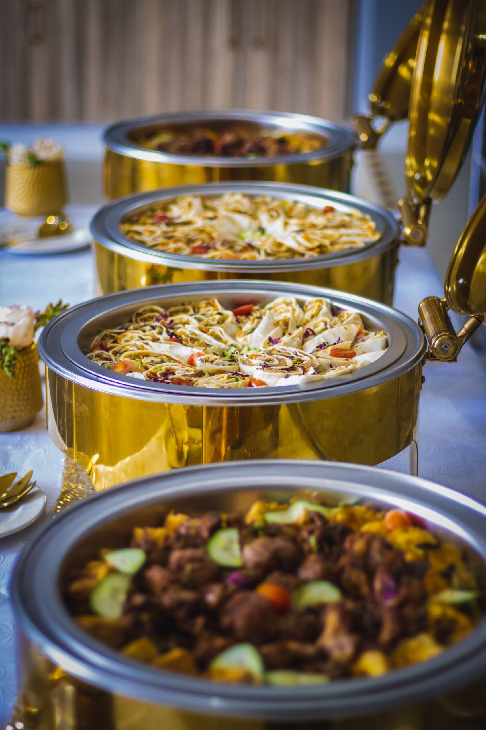 There are many different types of food in the pots on the table.