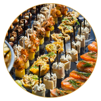 There are many different types of food on sticks on a table.