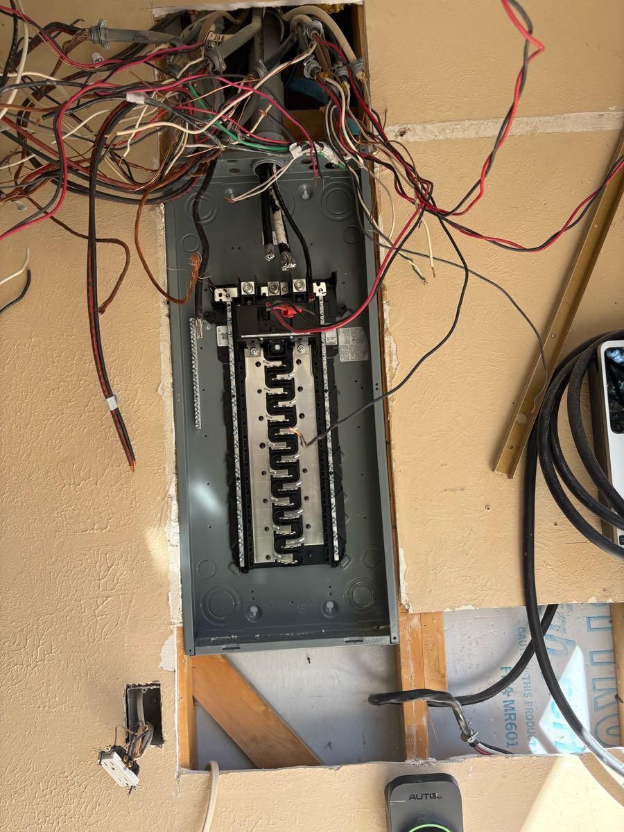 A very messy electrical box with a lot of wires coming out of it.