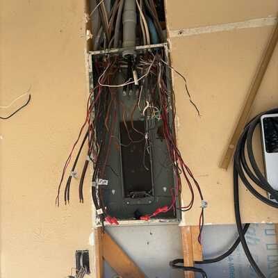 An electrical box with a lot of wires coming out of it.