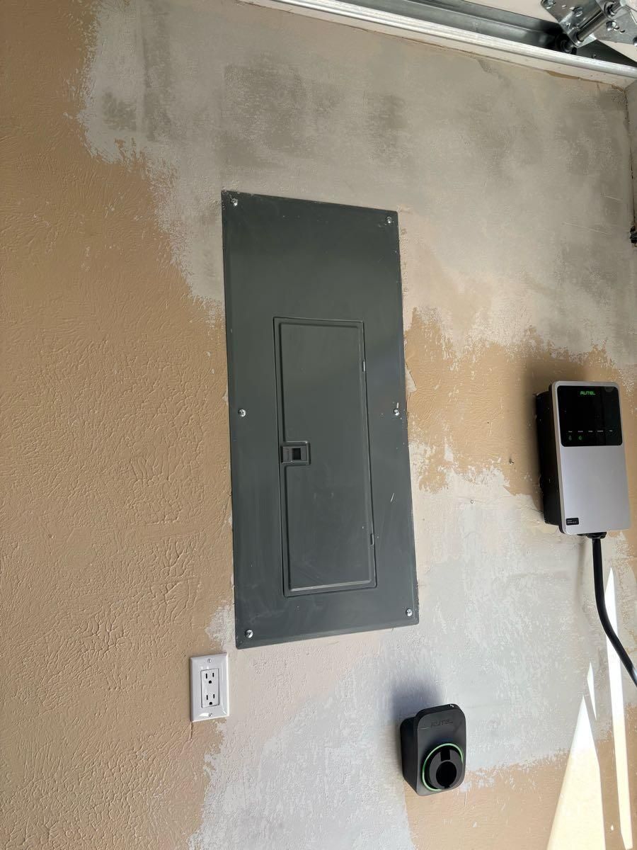 There is a electrical box on the wall in the garage.