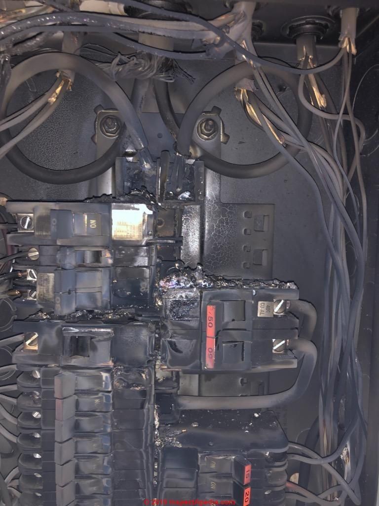 A close up of a electrical box with a lot of wires coming out of it.