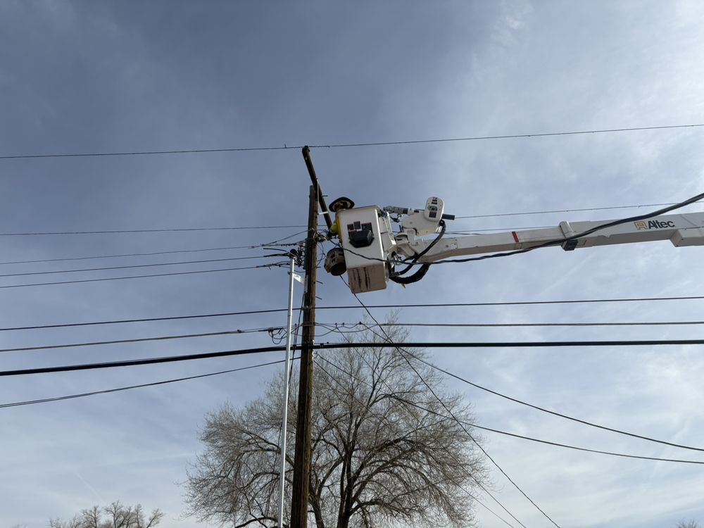 A man in a bucket is working on a power line.