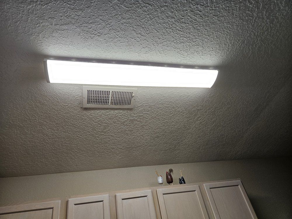 There is a light on the ceiling above the cabinets.