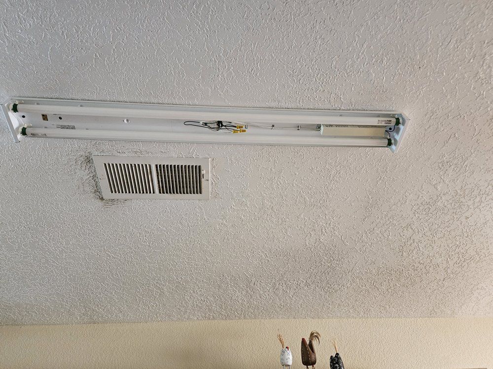 A light fixture is hanging from the ceiling in a room.