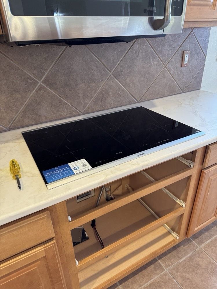 A kitchen with a stove top oven and a microwave.