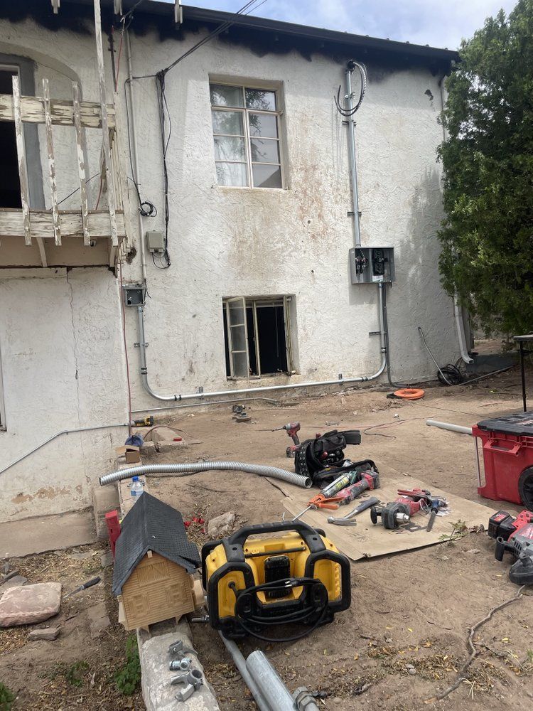 A large white building with a lot of tools in front of it.