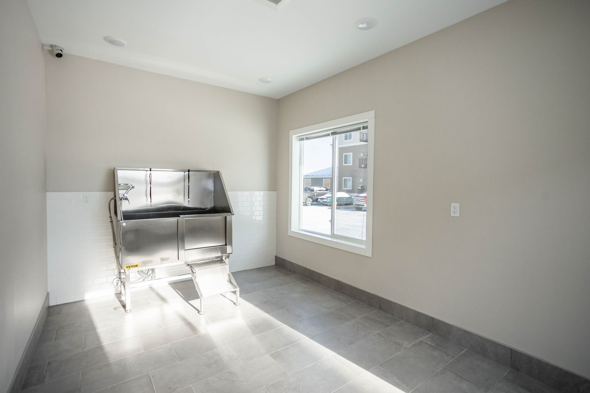A room with a sink and a window in it.