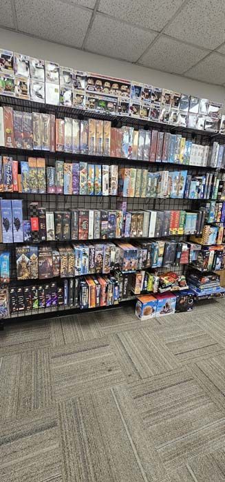 Shelves filled with board games in a store.