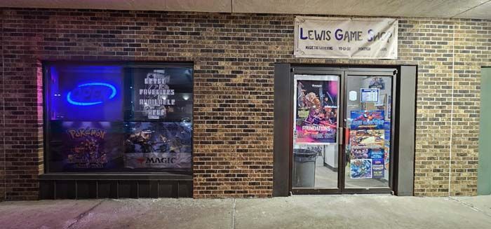 Exterior of a game store with brick walls, a blue neon sign in the window, and the name 