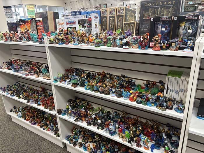 Shelves packed with colorful Skylanders figures in a store.
