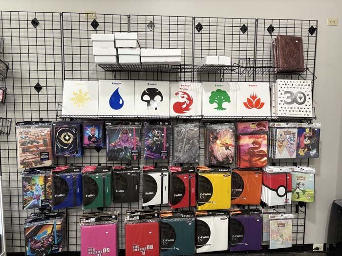 Wall display: Magic: The Gathering card sleeves, deck boxes, and accessories.