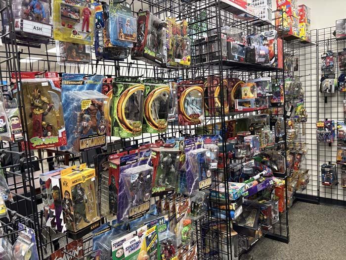 Shelves filled with action figures and toys in a store.