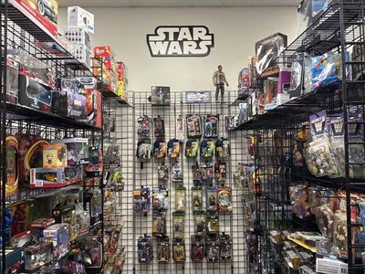 Toy store aisle stocked with Star Wars action figures and merchandise.