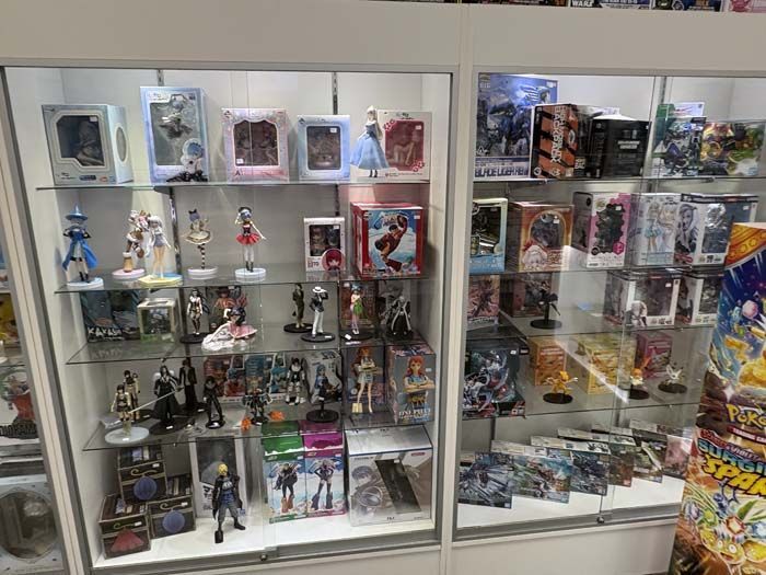 Display case filled with anime figures and merchandise in a store.