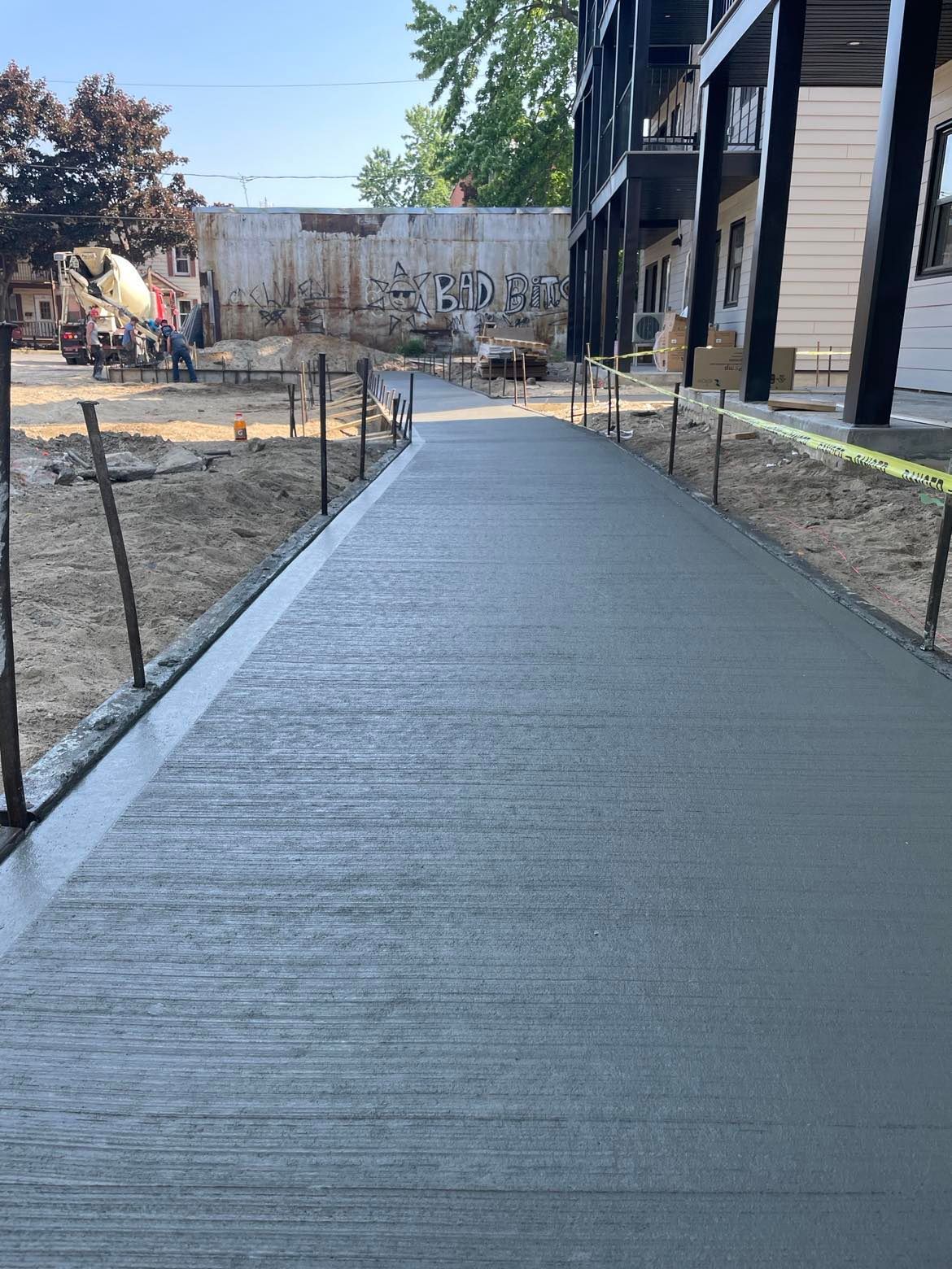 Une passerelle en béton menant à un bâtiment en construction.