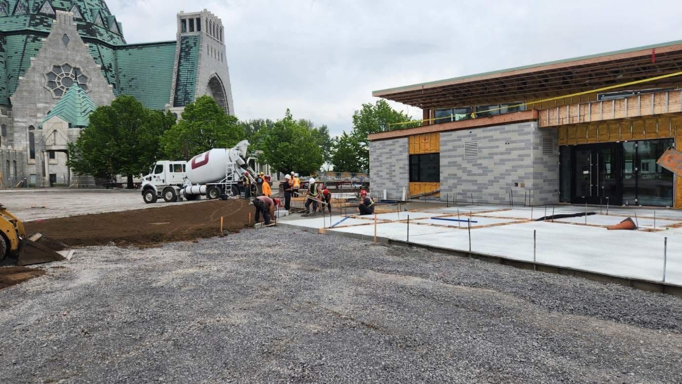 Un groupe de personnes travaille sur un chantier de construction devant une église.