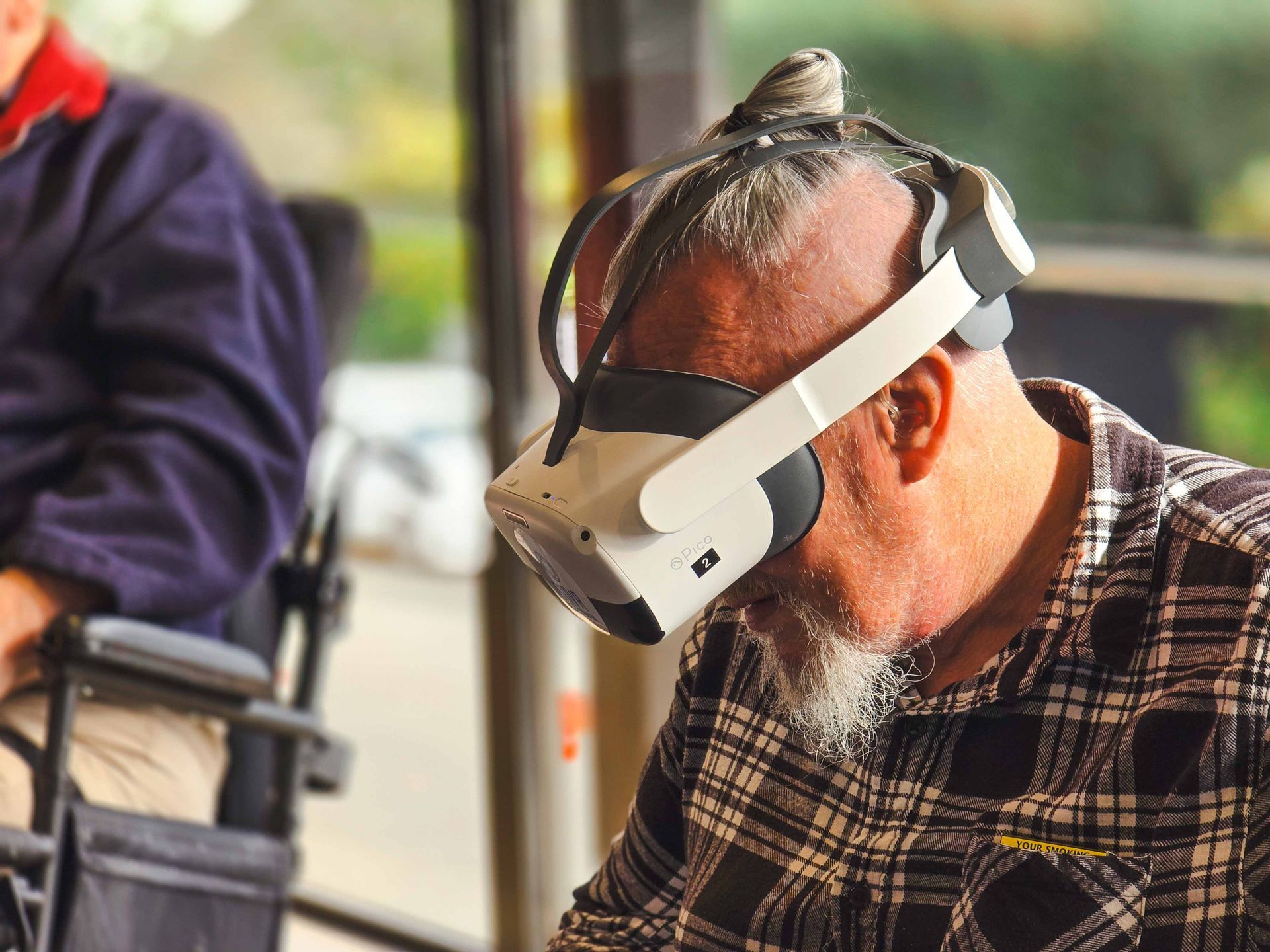 One of our Care Home residents wearing a VR Headset