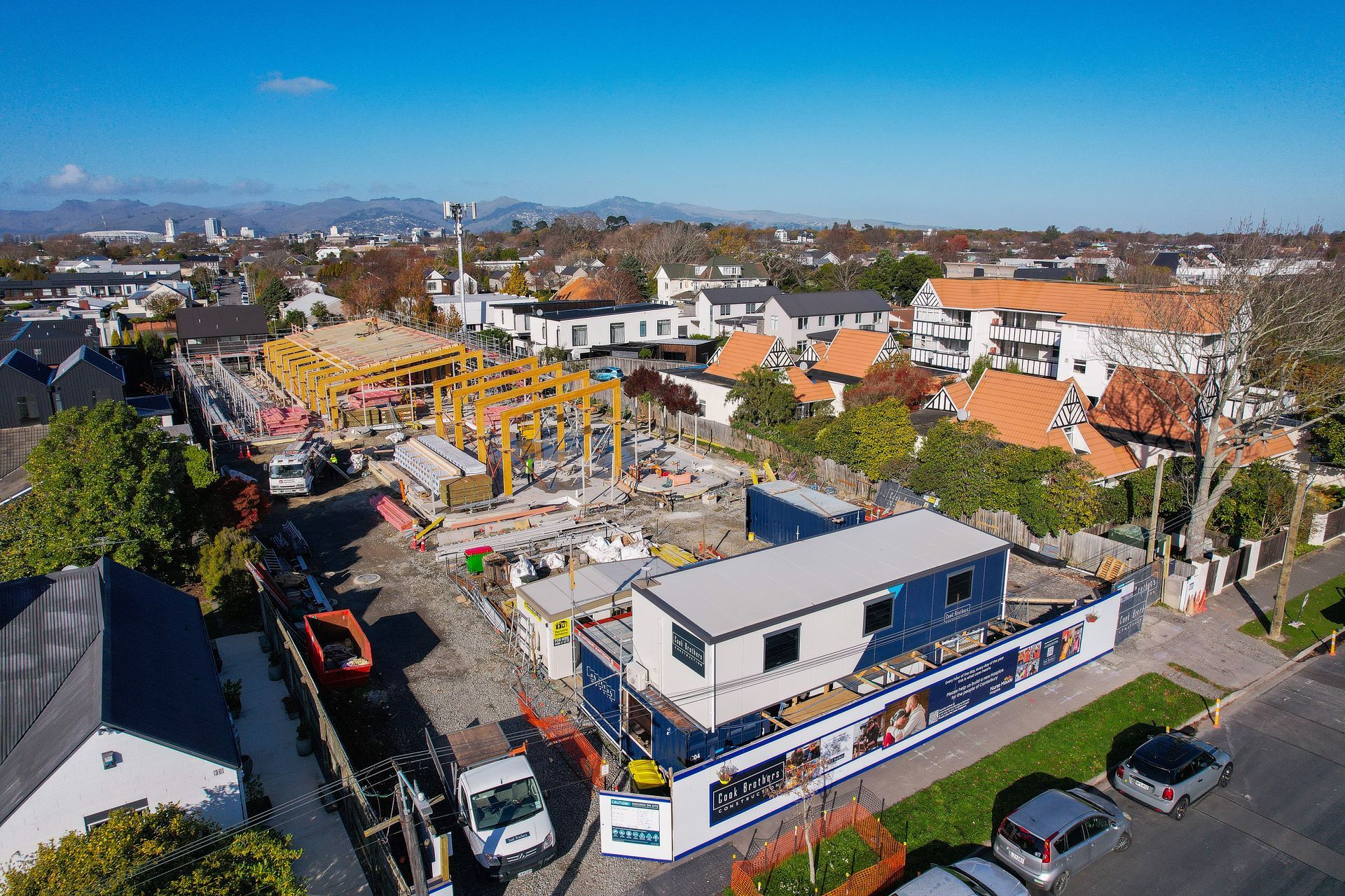 A building site with a crane in a semi residential area