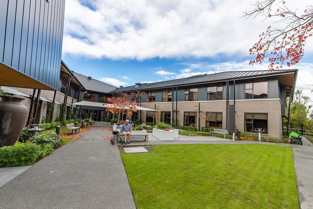 A large building with a lawn in front of it