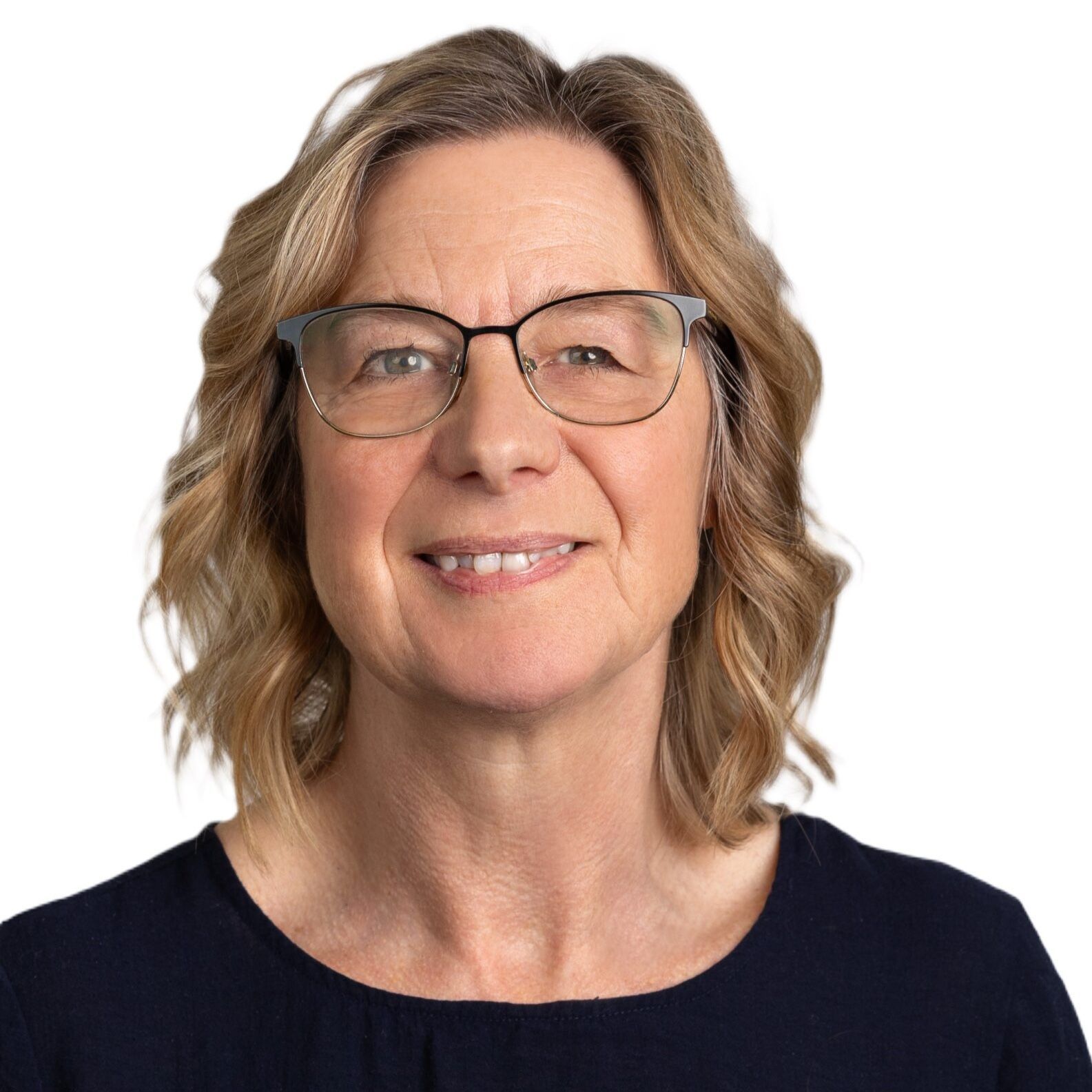 A woman wearing glasses and a blue shirt smiles for the camera. Jo Dowling