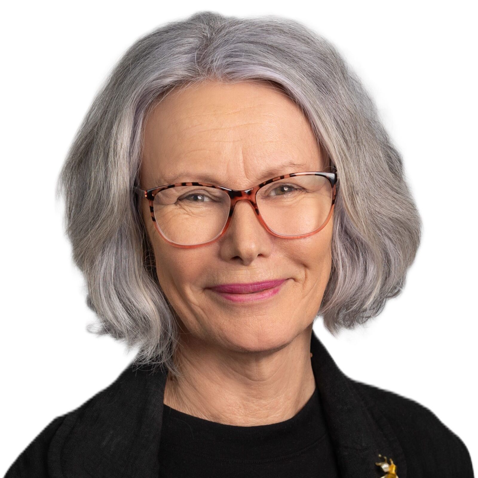 A woman wearing glasses and a black shirt smiles for the camera. Kim Rea