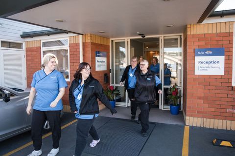 A group of nurses are walking into a hospital