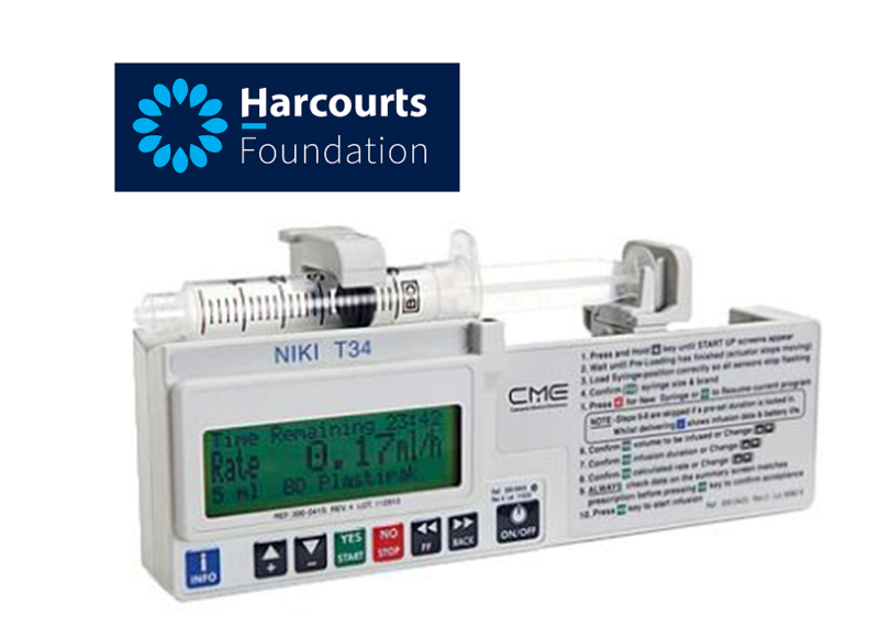 A syringe is attached to a device that says harcourts foundation