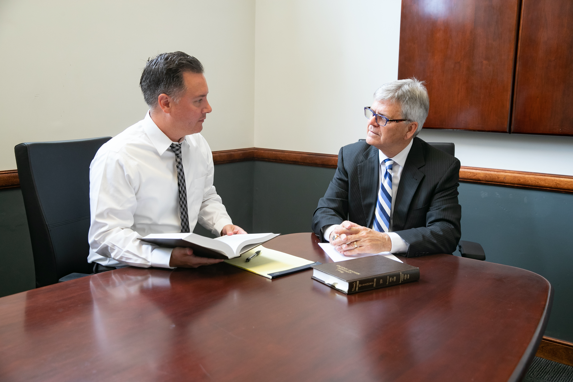 Attorney, Travis Lillie, speaking with Attorney, Larry Catt.