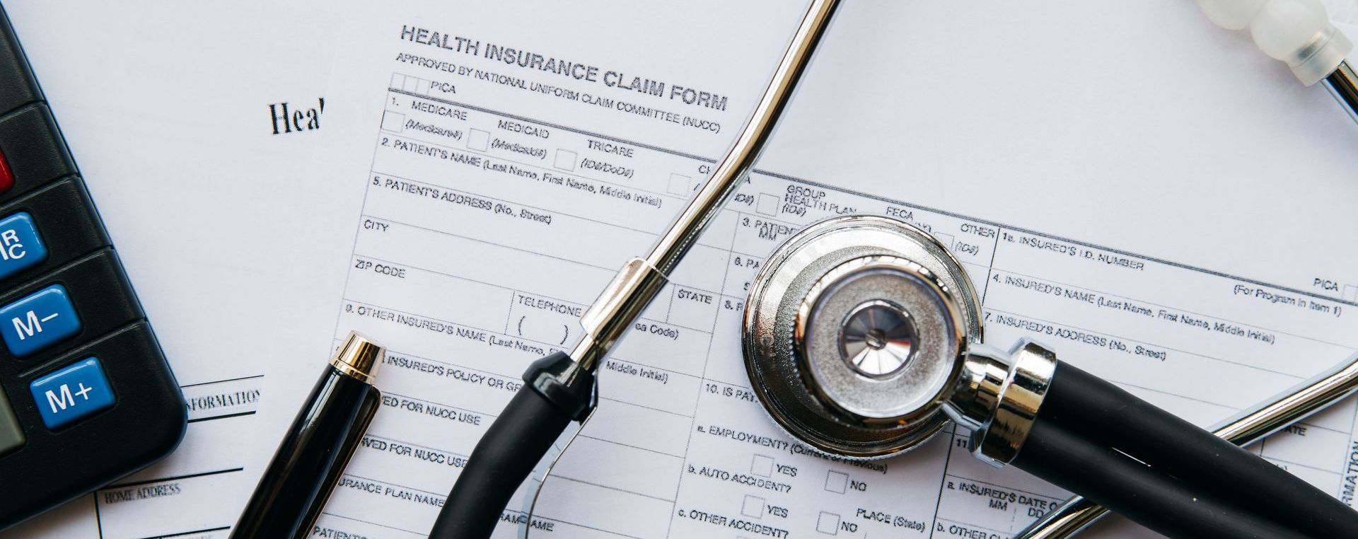 Health insurance claim form with a stethoscope on top of it.