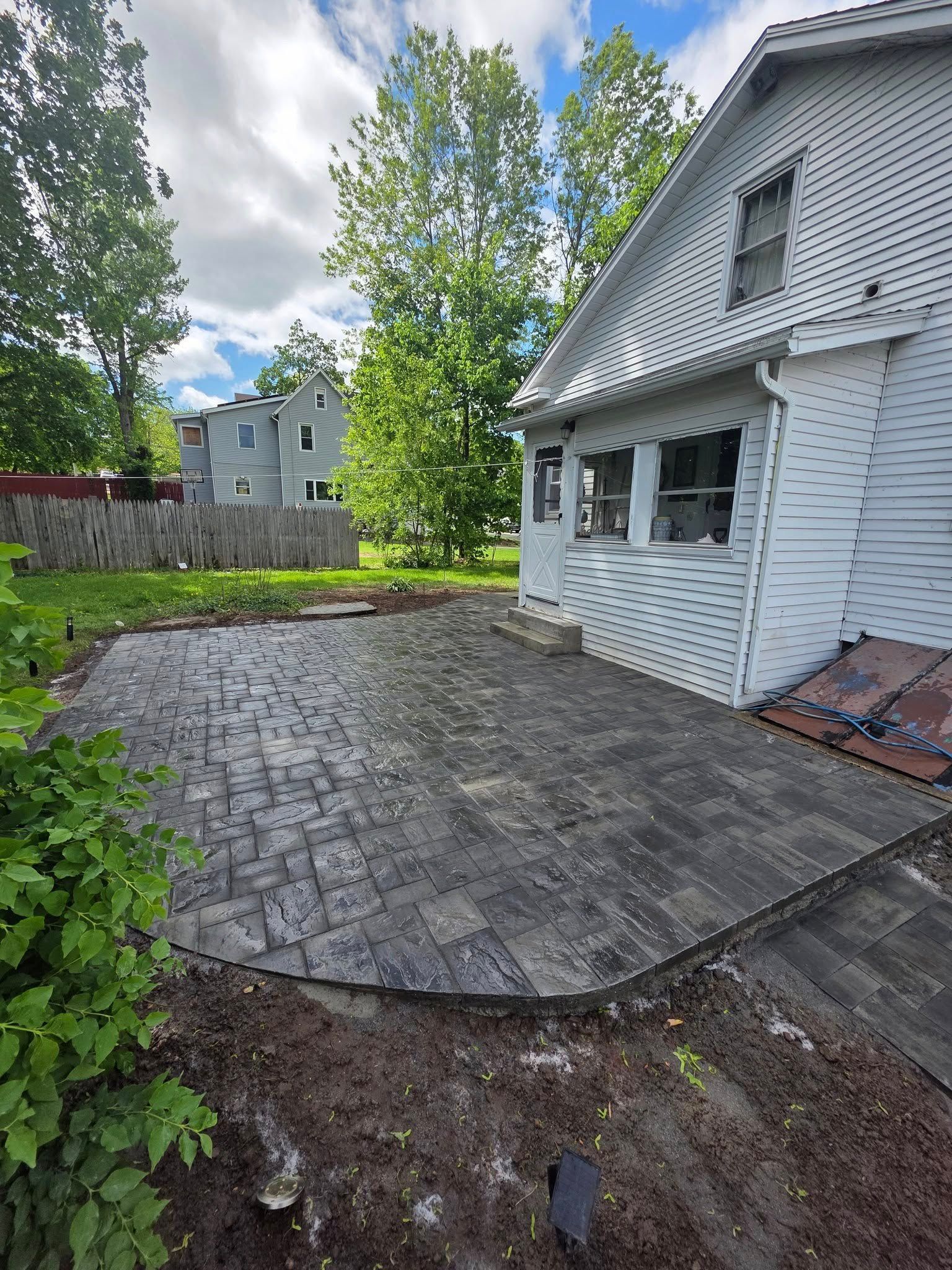 A white house with a patio in front of it.