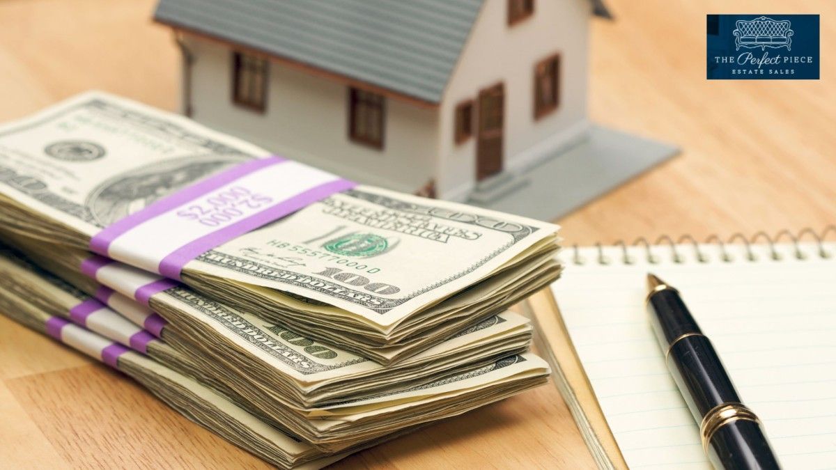 A stack of money next to a model house