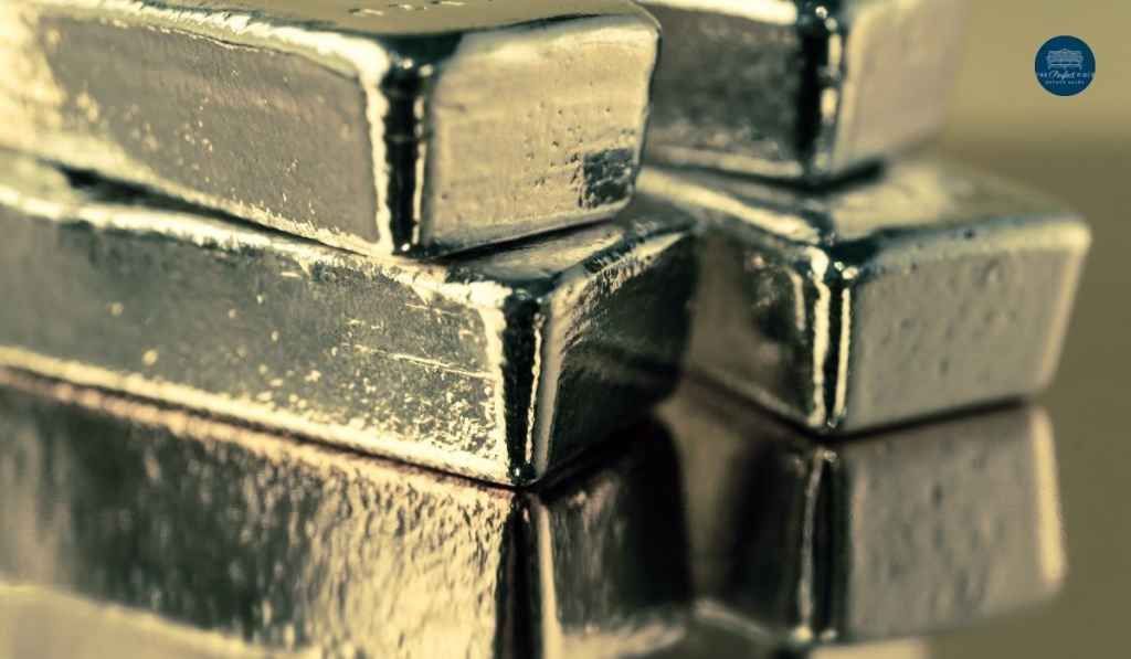 A stack of silver bars sitting on top of each other on a table.