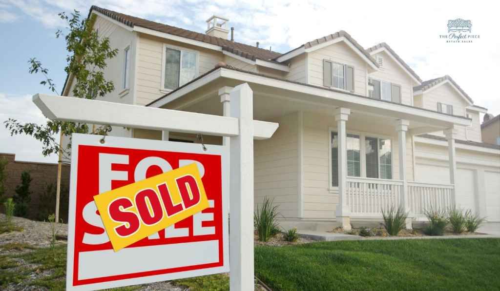 A house with a for sale sign in front of it