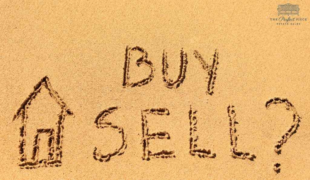 The words buy and sell are written in the sand