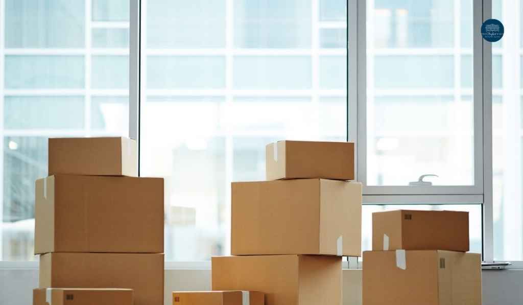 A bunch of cardboard boxes are stacked on top of each other in a room.