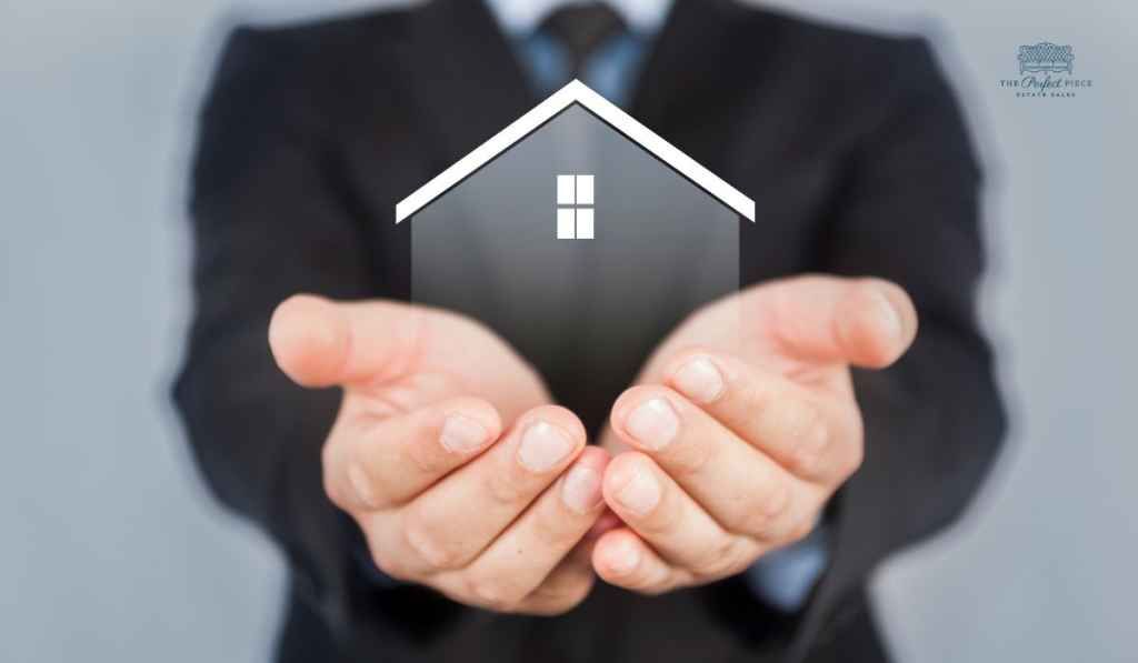 A man in a suit is holding a small house in his hands