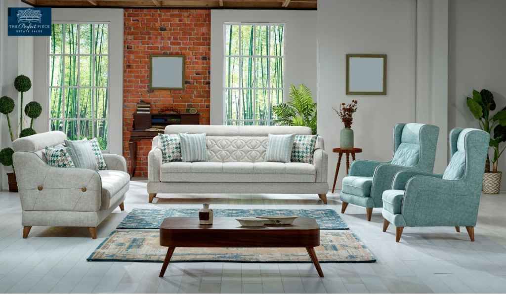 A living room with a couch , chairs , and a coffee table