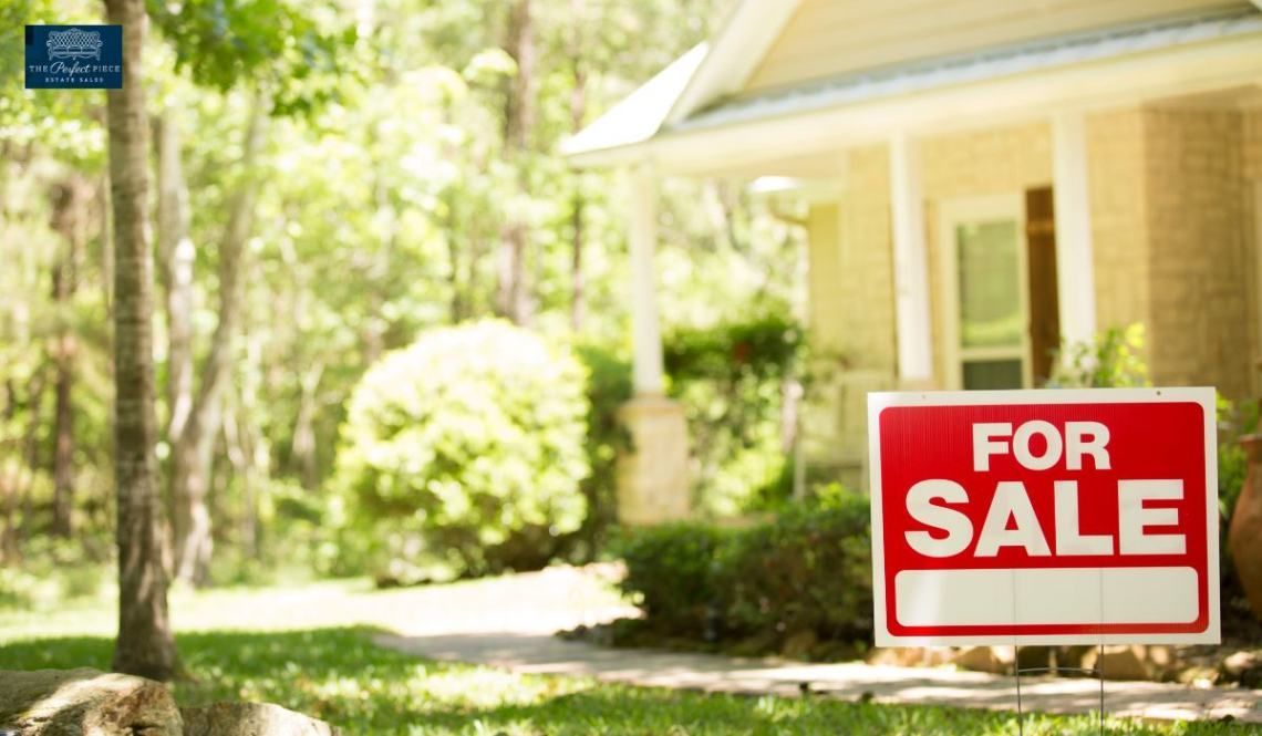 A house with a for sale sign in front of it