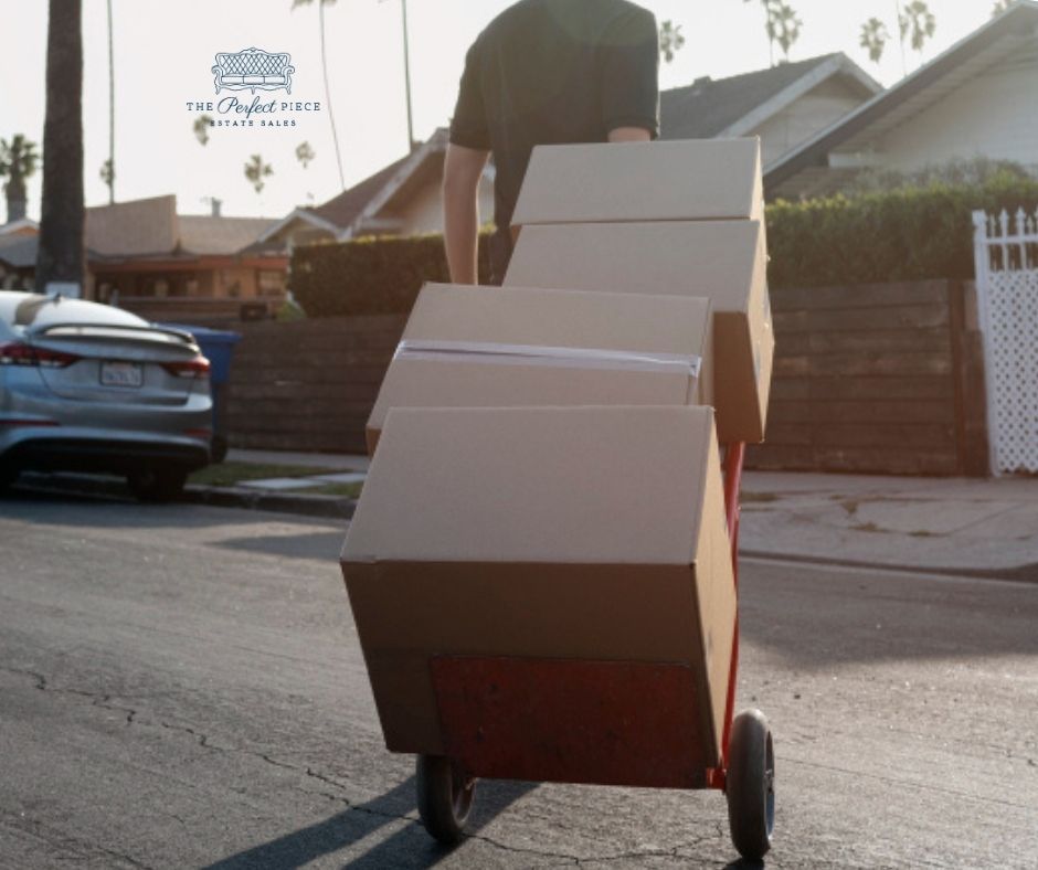 A man is pushing a cart full of cardboard boxes