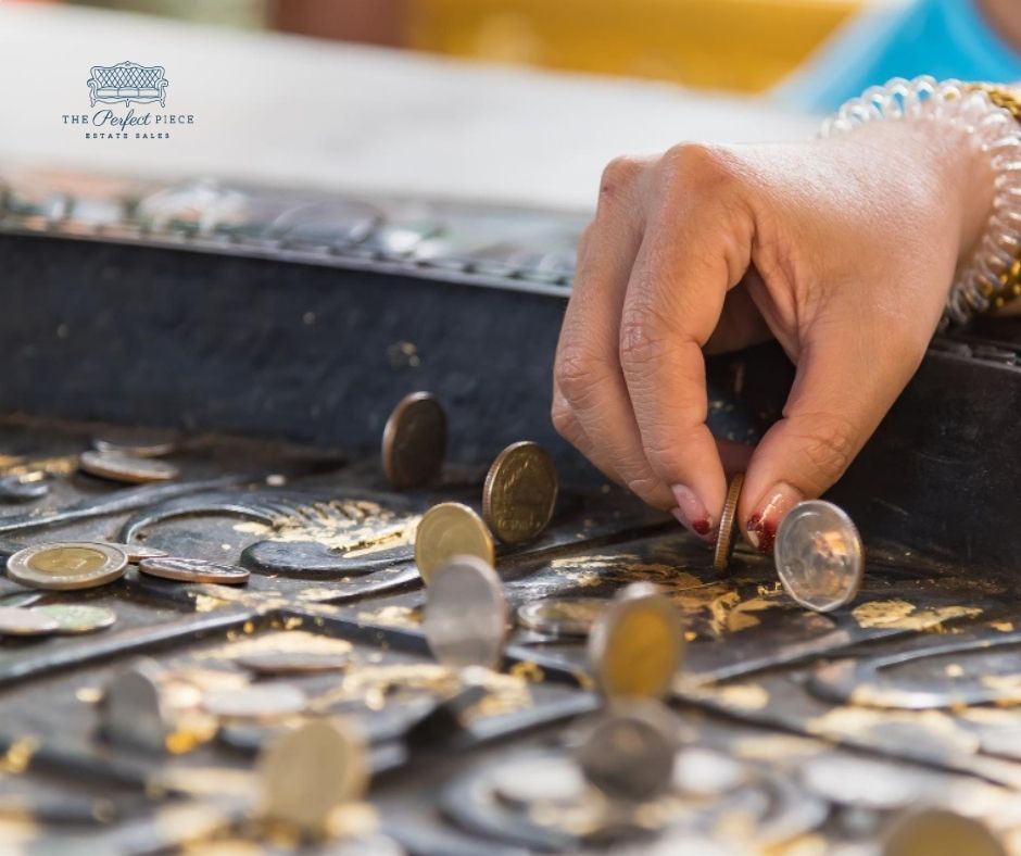 A woman is putting a coin into a tray of coins.