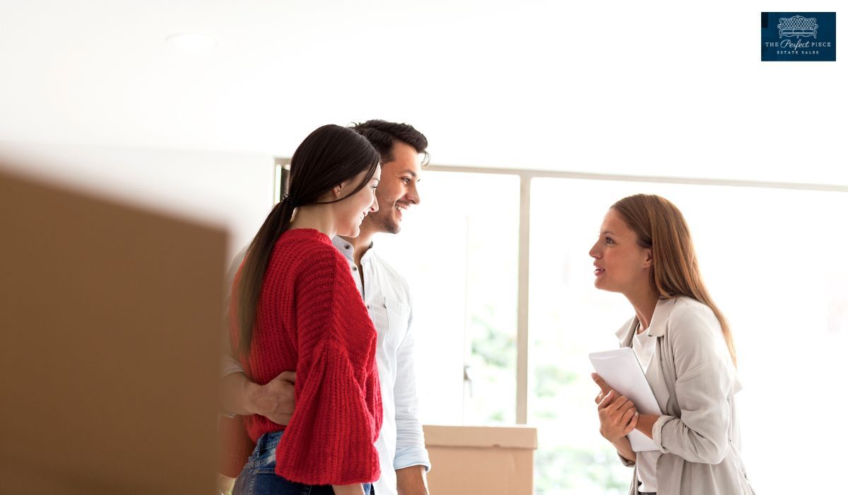 A woman is talking to a man and woman in a room.