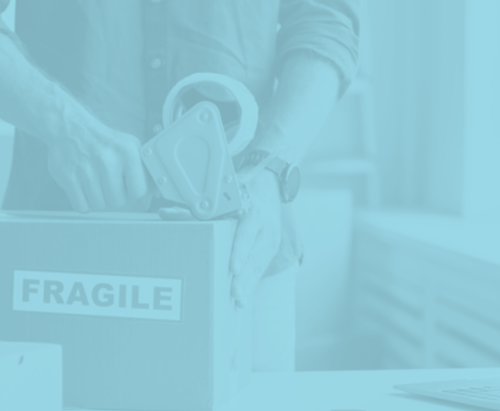 A person is wrapping a box with tape.