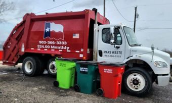 A Mars Waste garbage truck with a Texas flag.