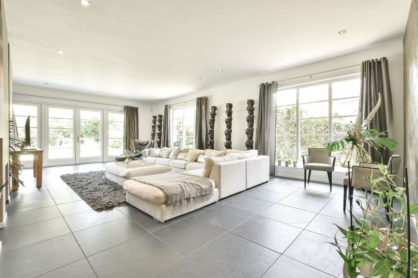 A person in black clothing mops a hardwood floor. A person in black clothing mops a hardwood floor.