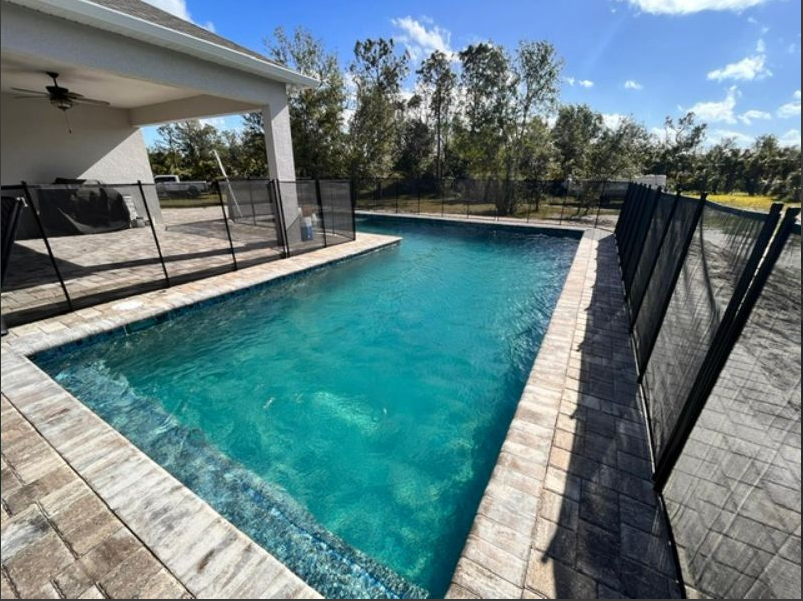 A large swimming pool with a fence around it