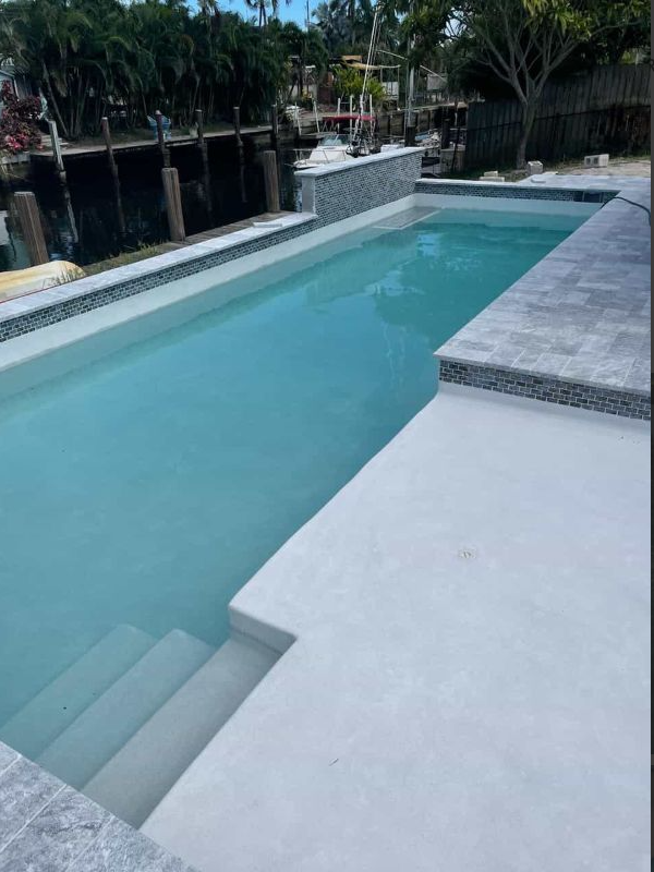 A large swimming pool with stairs leading to it