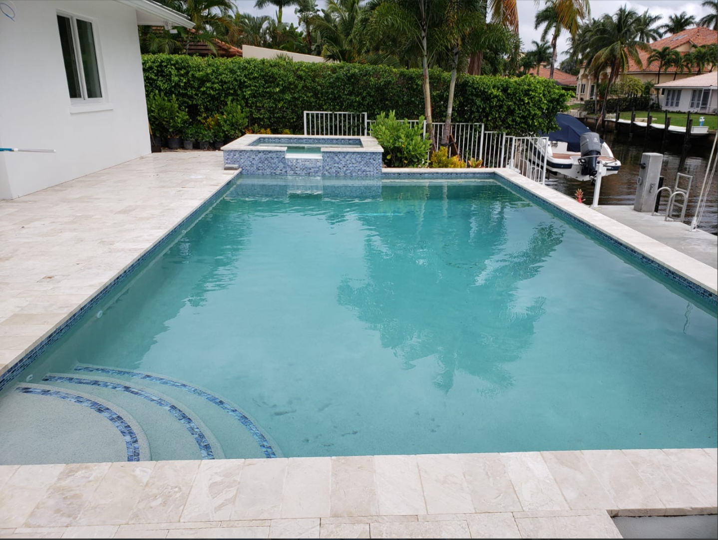 A large swimming pool with a boat in the background