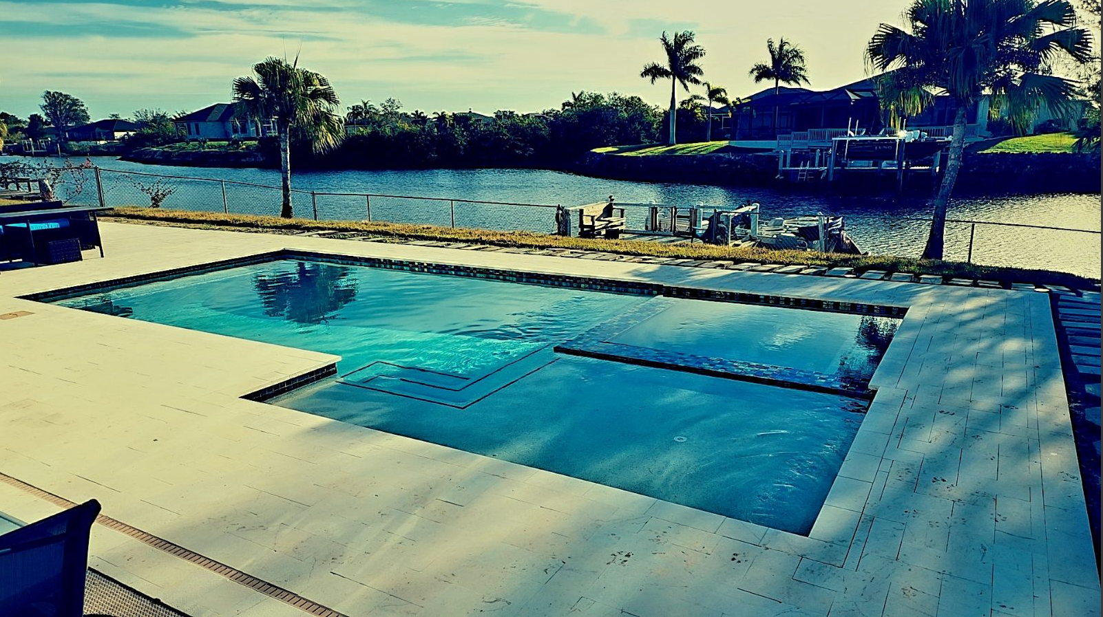 There is a large swimming pool in the middle of a lake.